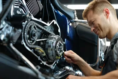 Technician working on a motorcycle, workshop reference